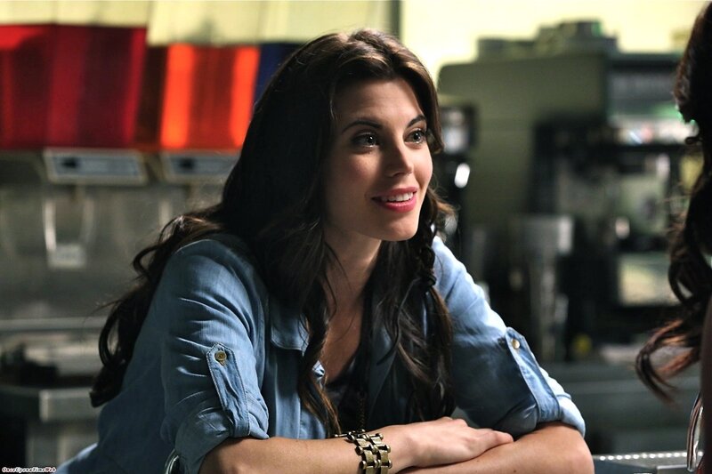 woman in denim shirt smiling