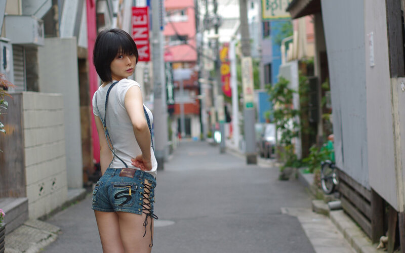 woman in denim shorts on street