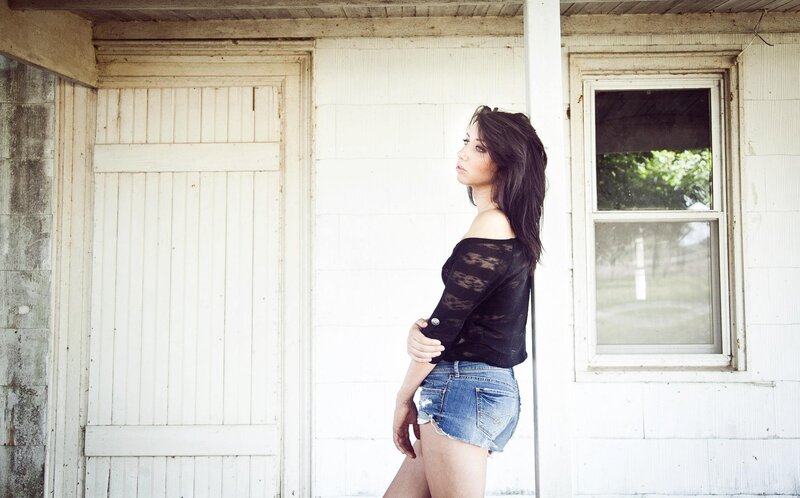 woman in denim shorts standing outside