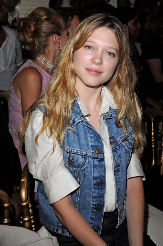 woman in denim vest at event
