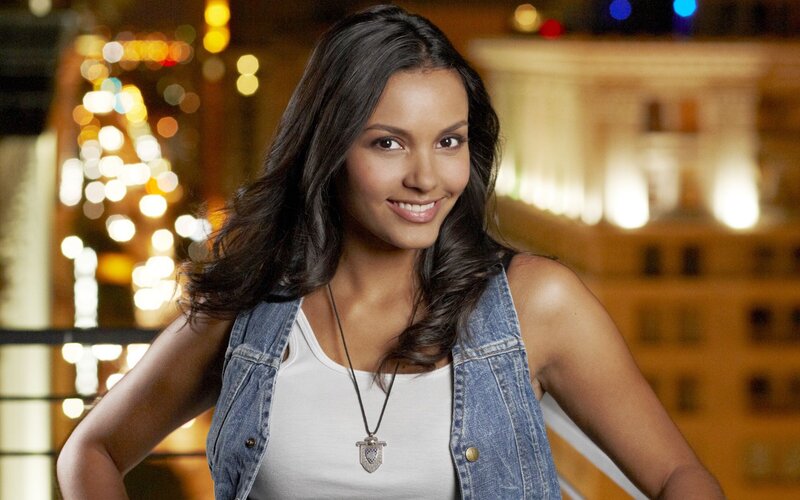 woman in denim vest smiling