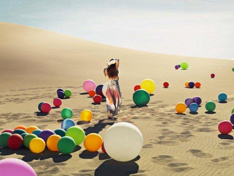 Woman in Desert with Balls