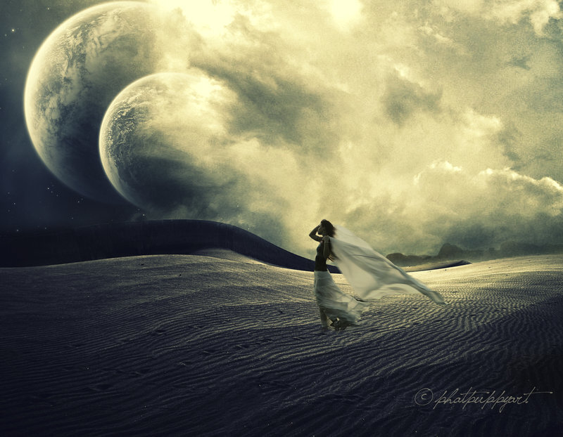 woman in desert with twin planets