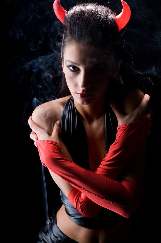 woman in devil costume with smoke
