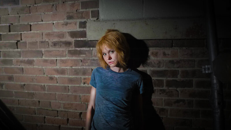 woman in dimly lit room