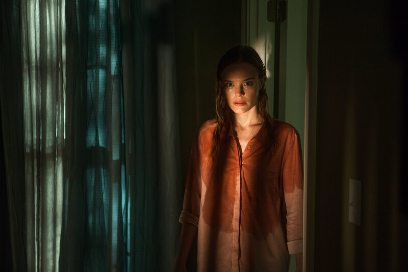 woman in dimly lit room