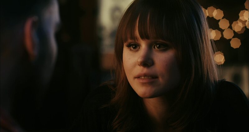 woman in dimly lit room