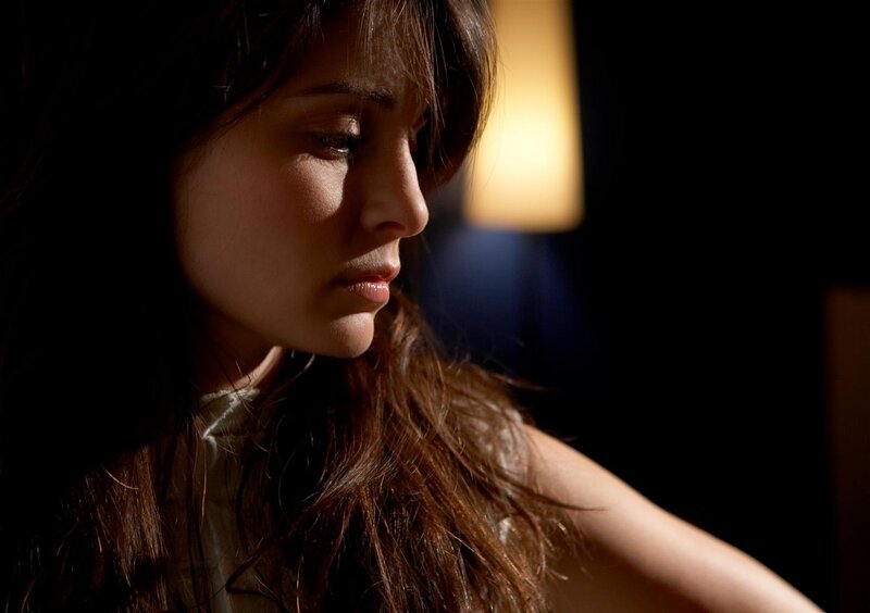 woman in dimly lit room