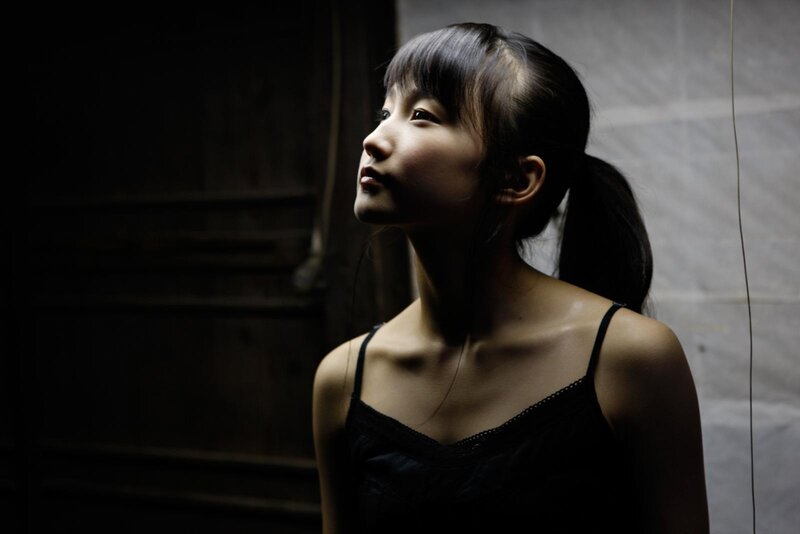 woman in dimly lit room
