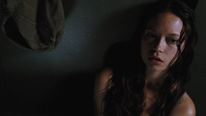 woman in dimly lit room