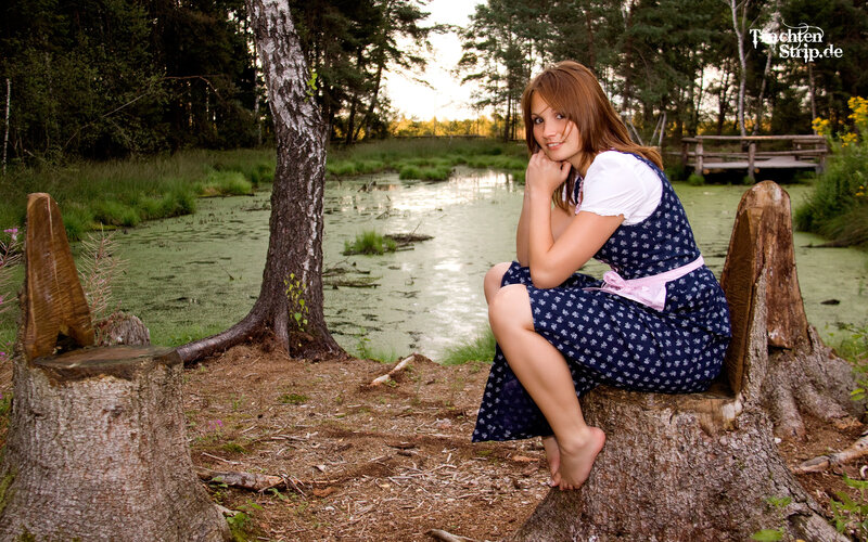 Woman in dirndl by pond