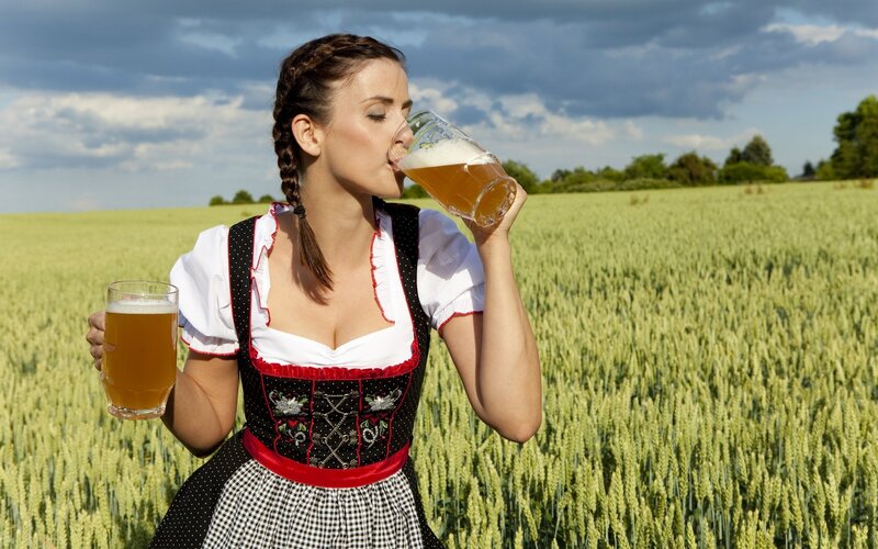 Woman in Dirndl Drinking Beer — Green, Serene