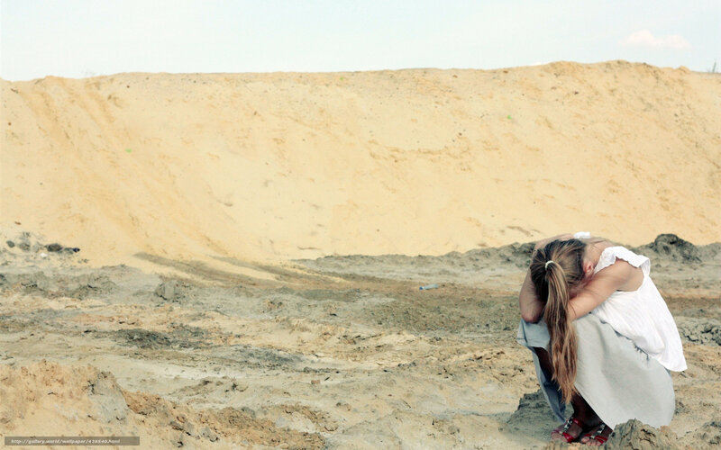 woman in distress on a sand dune