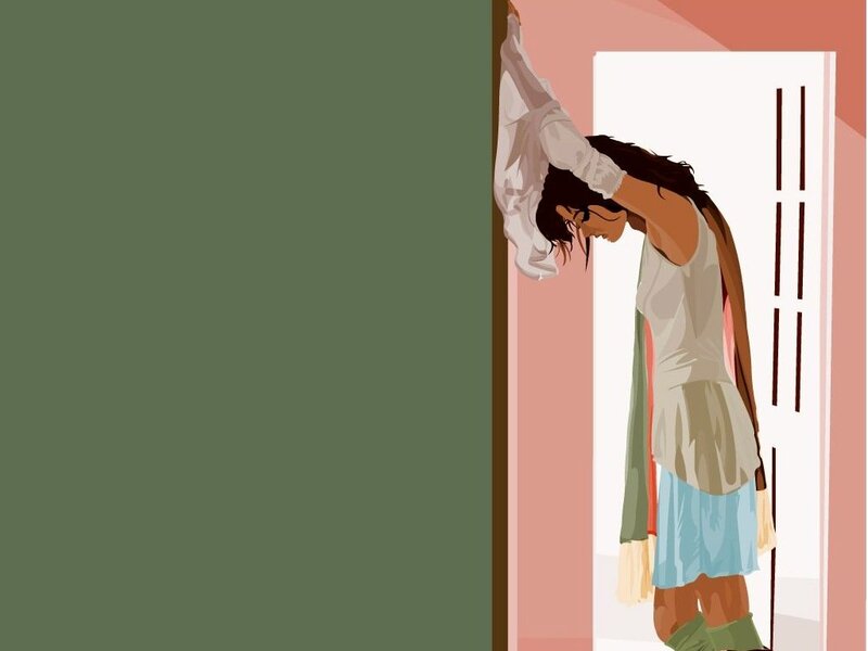 woman in doorway with head down
