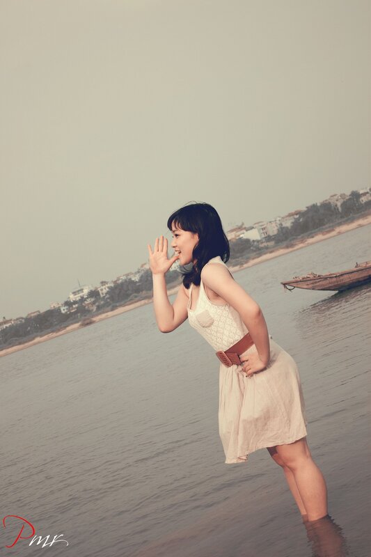 woman in dress at the water's edge