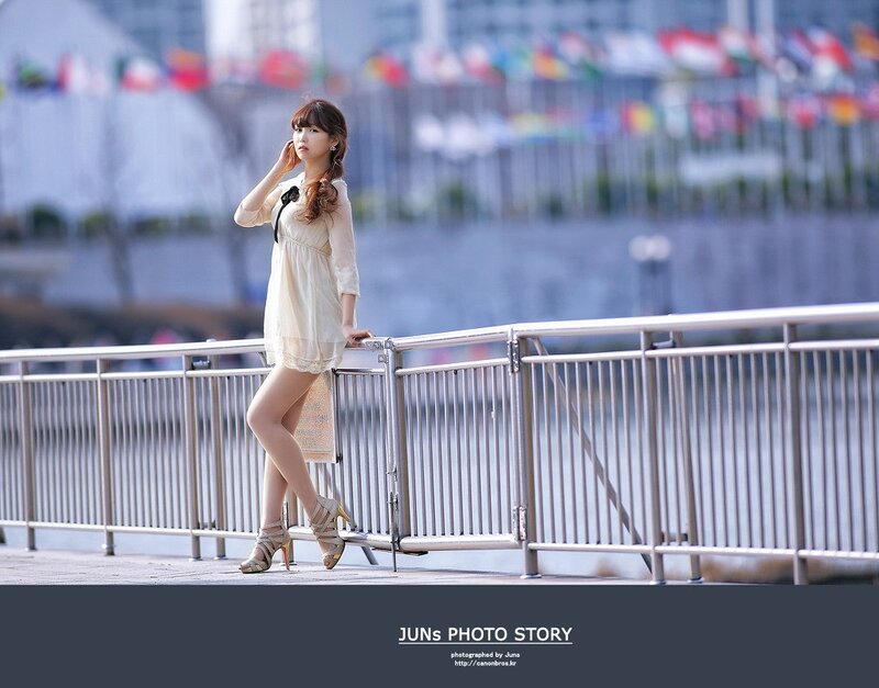 Woman in dress by railing