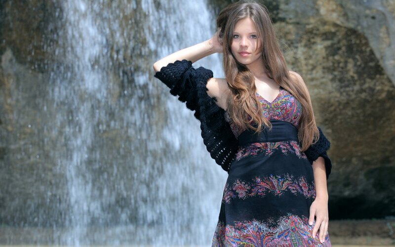 woman in dress by waterfall