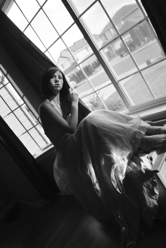 woman in dress by window