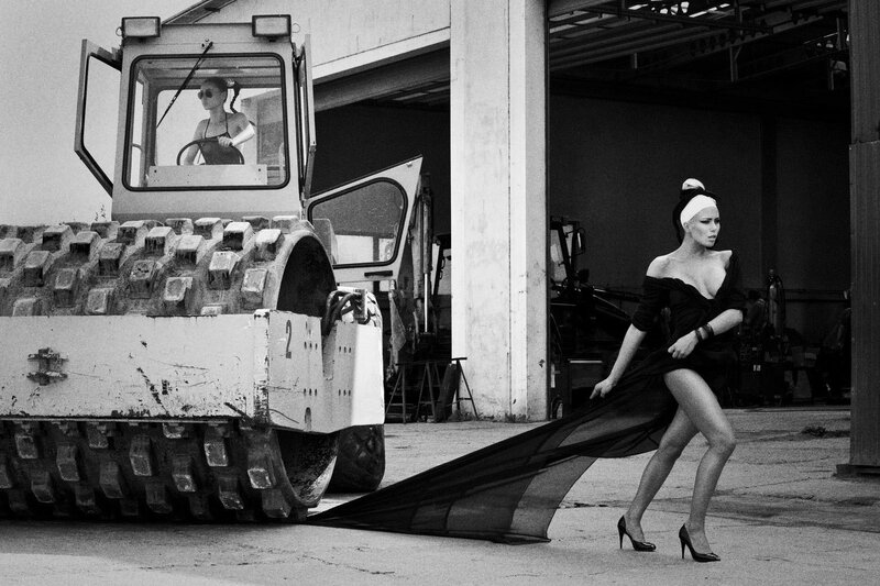 Woman in dress near construction vehicle