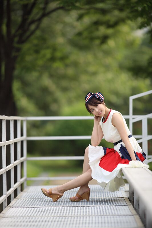Woman in dress on a bridge