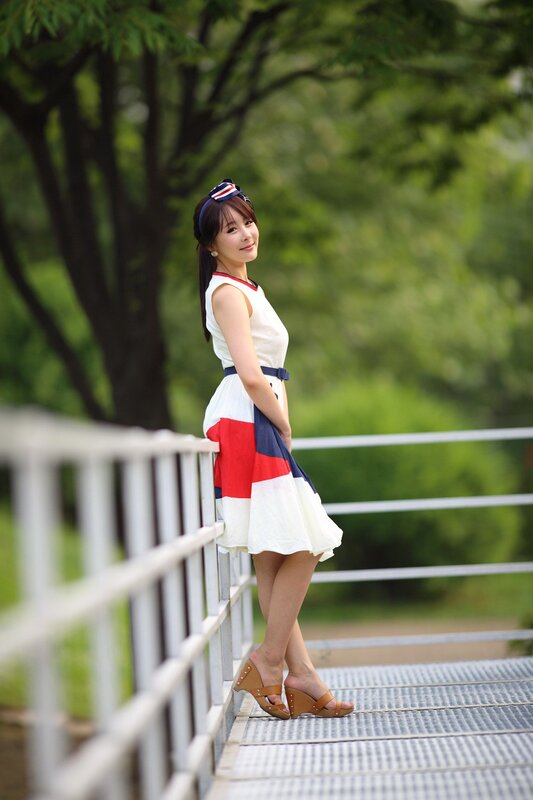 woman in dress on bridge