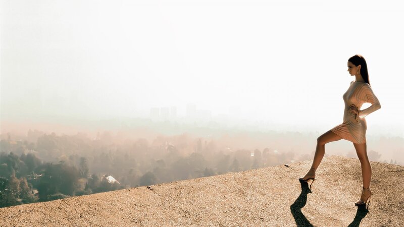 woman in dress on hilltop