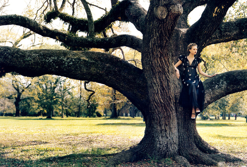 Woman in dress on tree branch
