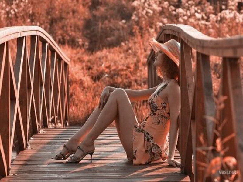 Woman in dress on wooden bridge