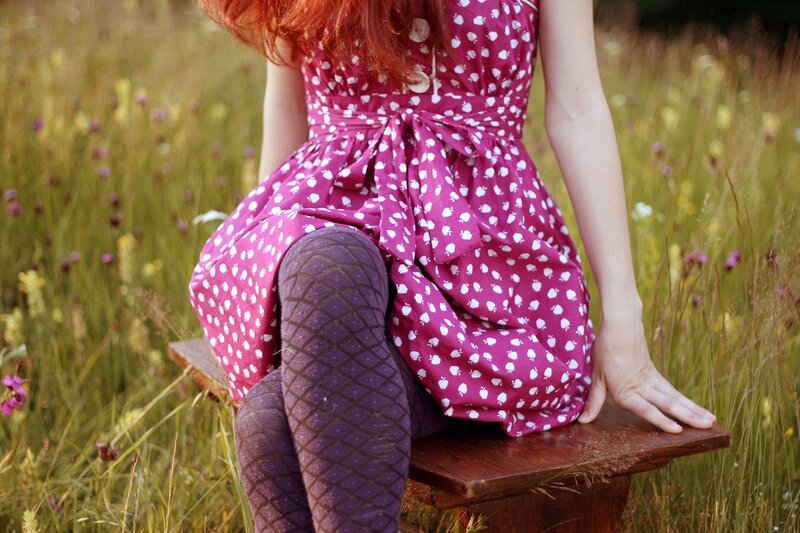 Woman in dress sitting on bench