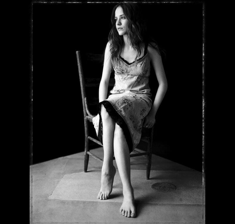 woman in dress sitting on chair