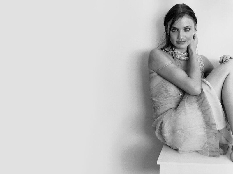 woman in dress sitting on wall
