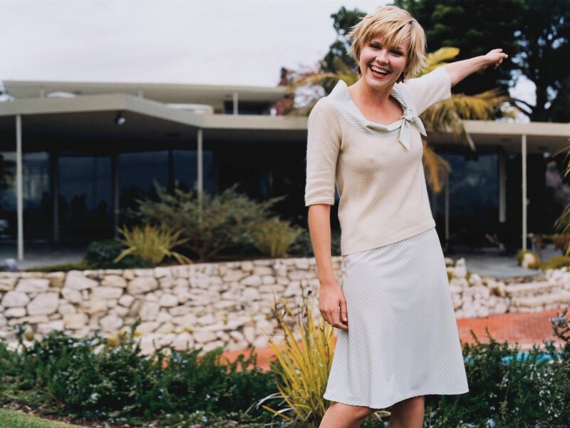 Woman in dress smiling outside