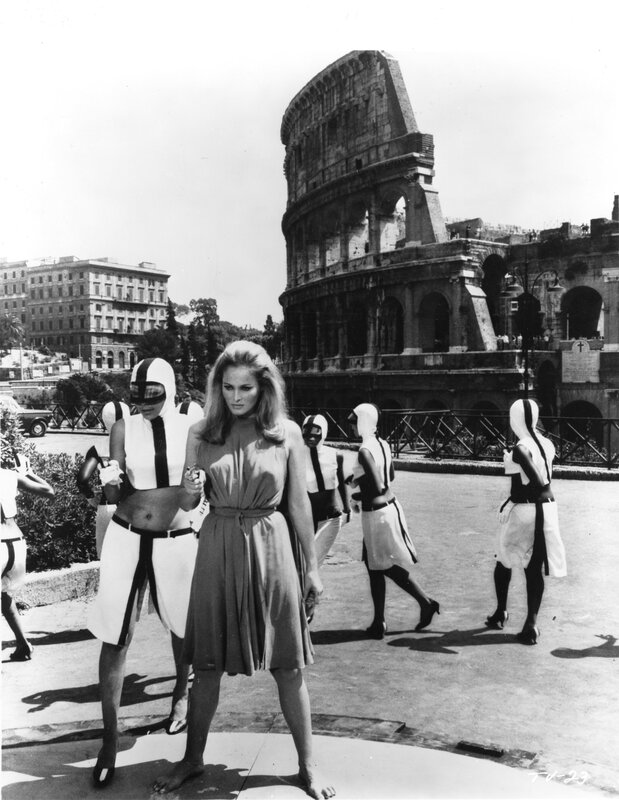 Woman in dress with guards at Colosseum