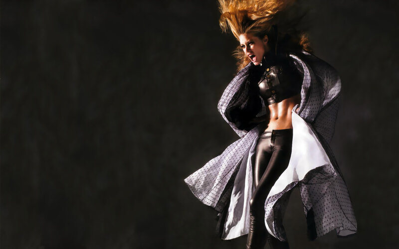 woman in dynamic pose with flowing coat
