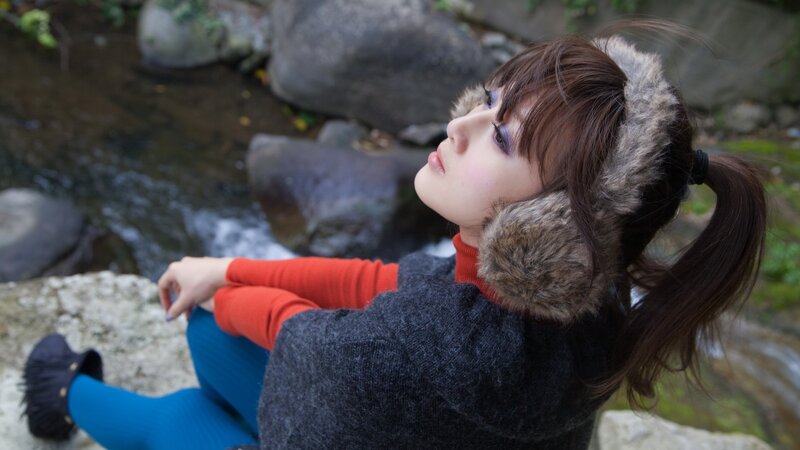 woman in earmuffs by stream