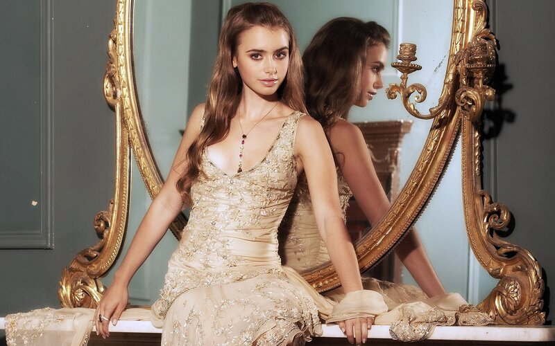 Woman in elegant gown by mirror