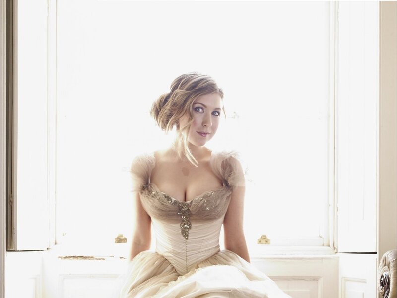 woman in elegant gown by window