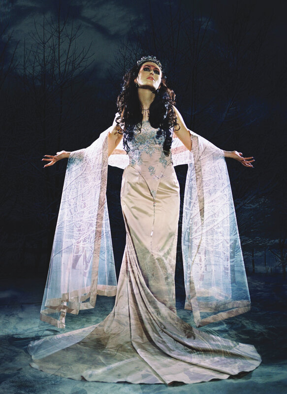 woman in elegant gown with cape