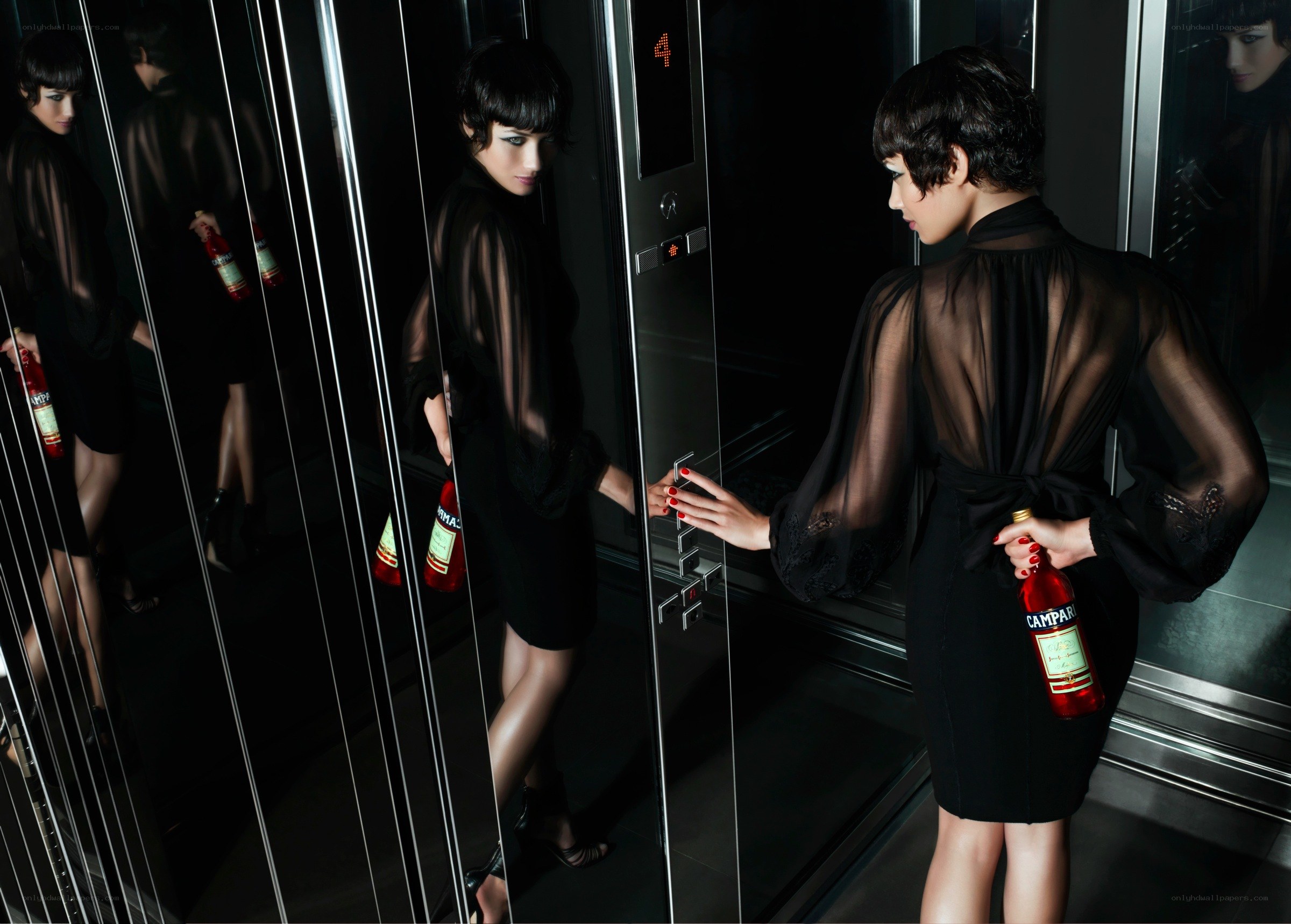 Woman in elevator with bottle