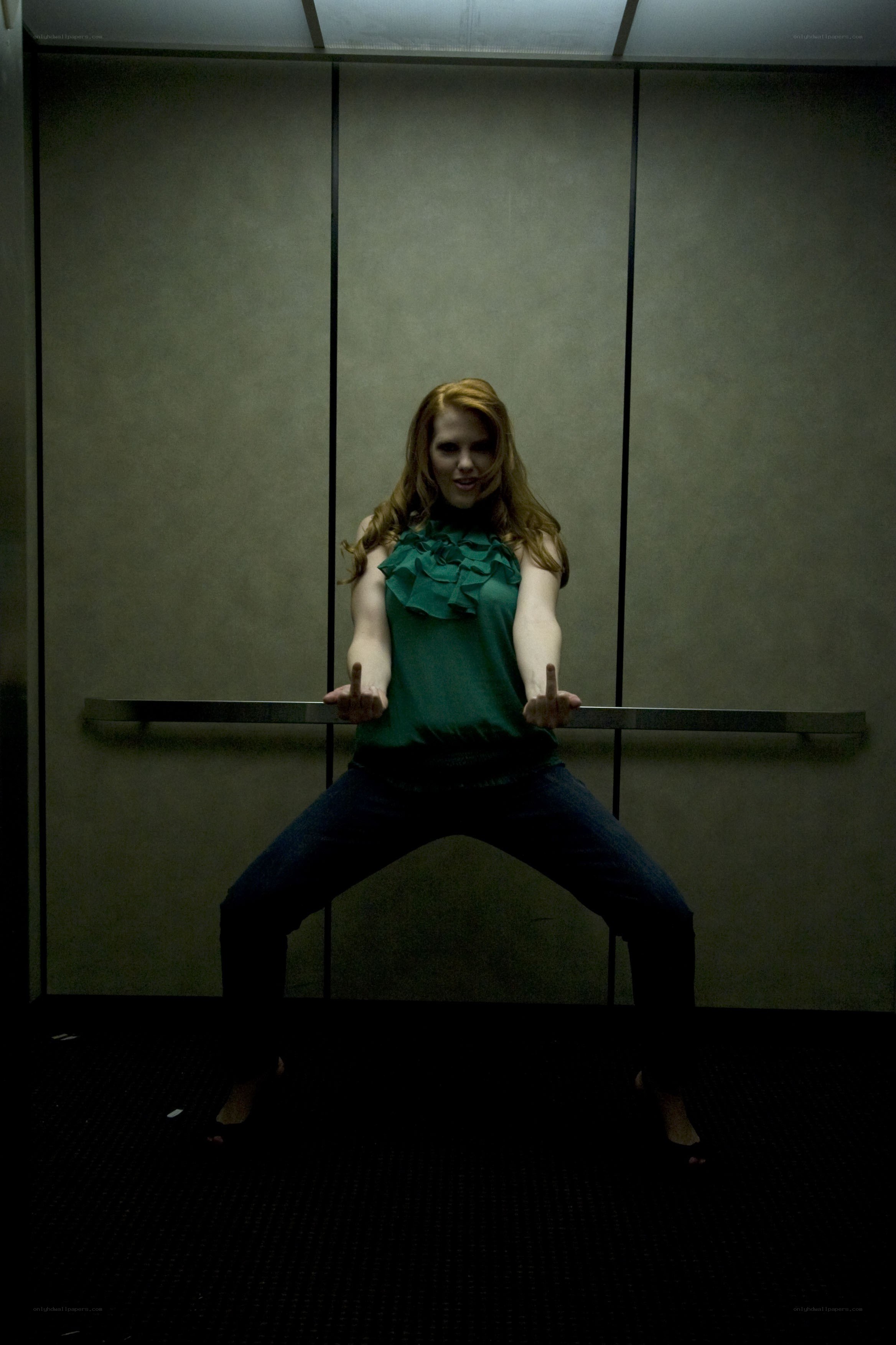 Woman in elevator with hand gesture