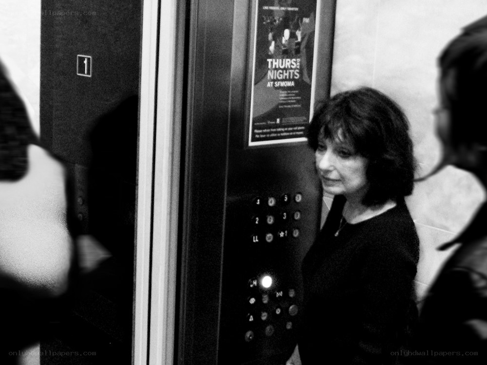 Woman in elevator with poster