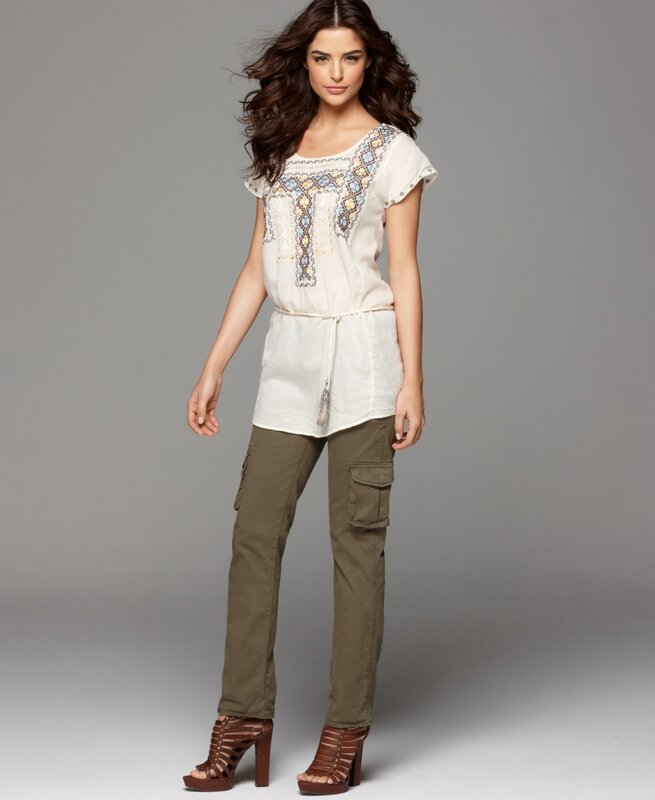 woman in embroidered top and cargo pants