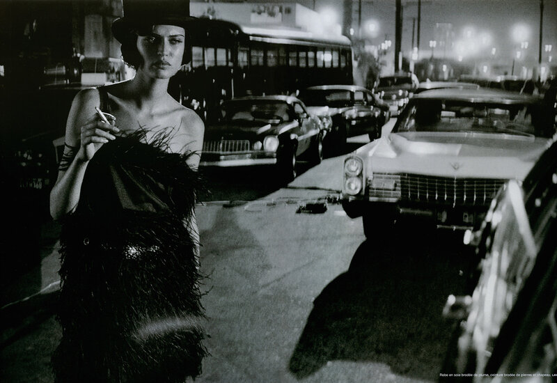 Woman in feather dress on city street