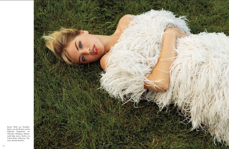 woman in feather dress on grass
