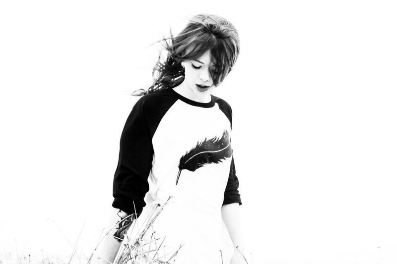 woman in feather shirt