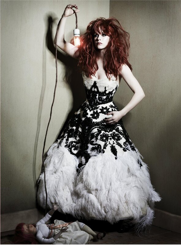 Woman in feathered gown with lightbulb
