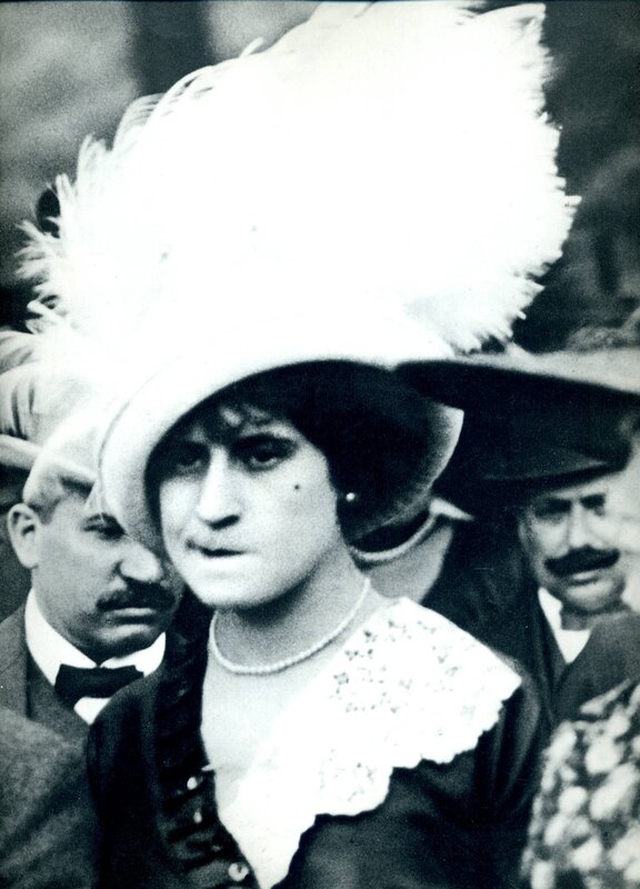 Woman in feathered hat at event