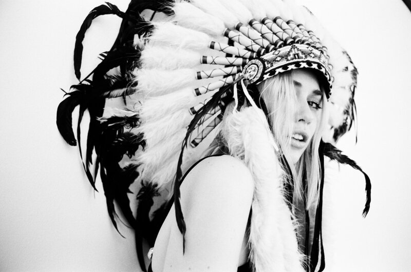 woman in feathered headdress