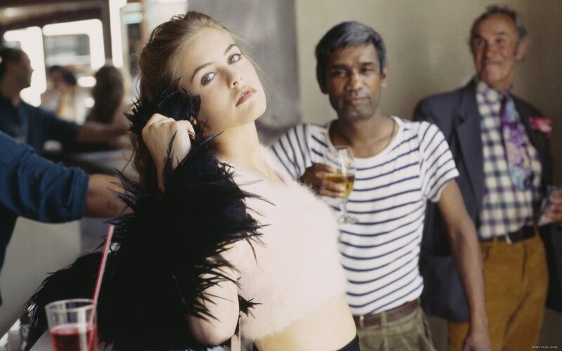 Woman in feathered top at bar