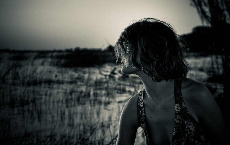 woman in field at dusk